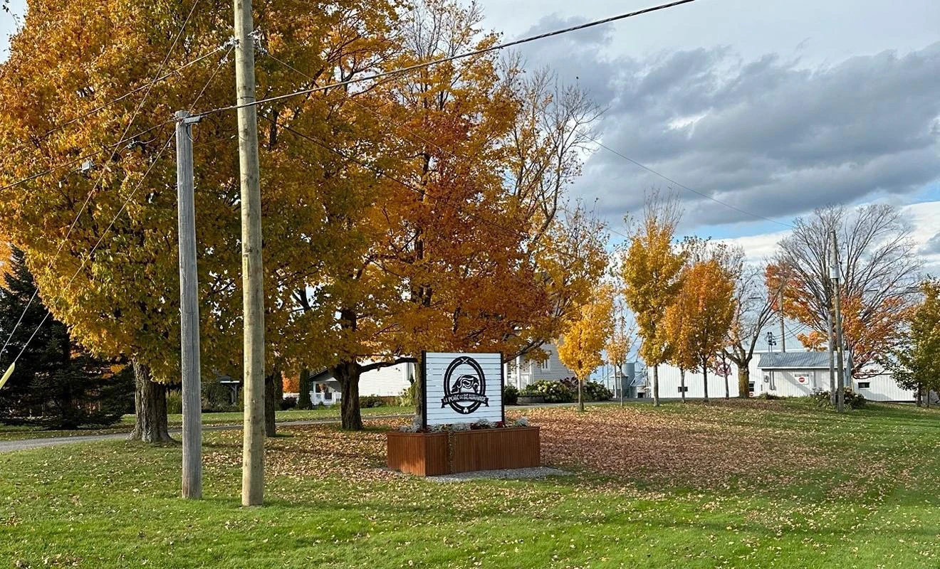 Panneau devant arbres aux feuilles d'automne.
