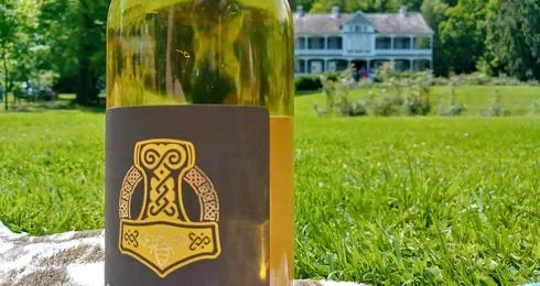 Bouteille sur gazon devant maison ancienne